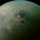 A false-color mosaic Titan’s polar regions. Kraken Mare is the dim splotch to the right of center.